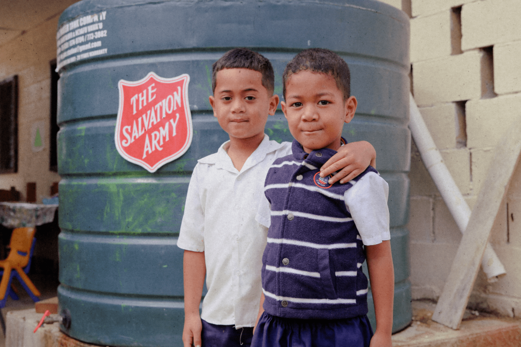Children in front of a Salvation army water tank